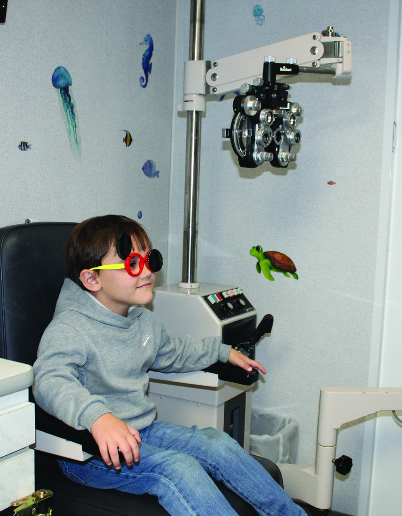 Kindergartner Caleb Klein wears occluders, which are used to assess various aspects of vision, such as visual acuity.