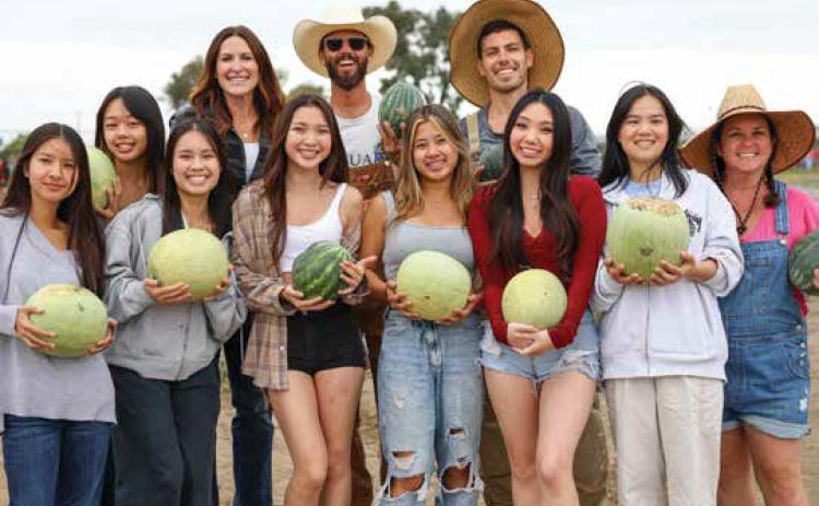 Westminster High School students, staff and volunteers harvest watermelons grown on campus farm. Photo Provided
