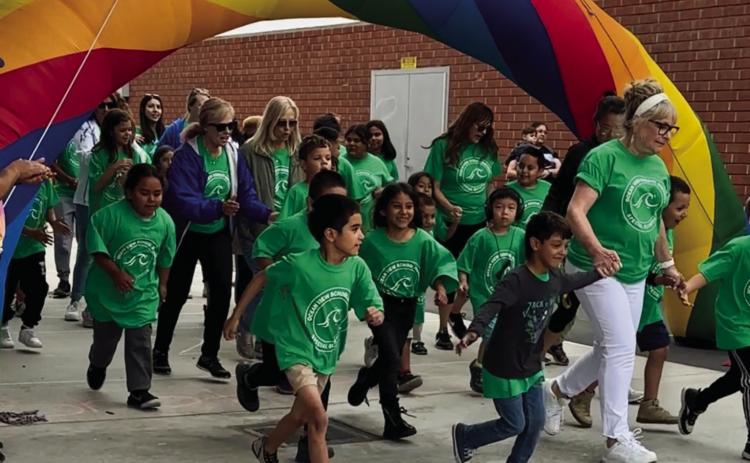 Students had the opportunity to run through the arch for the opening ceremony parade.
