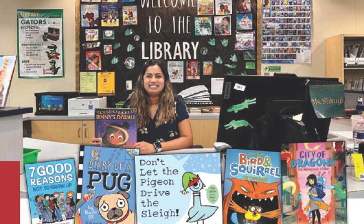 Shiragi Bhakta helps Gisler students find books they need to succeed. Photo Provided
