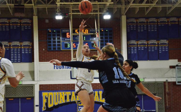 Guard Victoria Om rises above the defense to shoot. Photo by Uy Pham