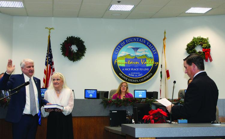 Incoming Mayor Glenn Grandis swears his oath with his mother, Pauline Grandis, holding the bible. Photo by SCOTT ROGERS / Fountain Valley Living Magazine