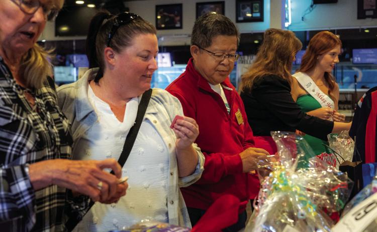 Bidding on a silent auction item at last year's Miss Fountain Valley fundraiser.