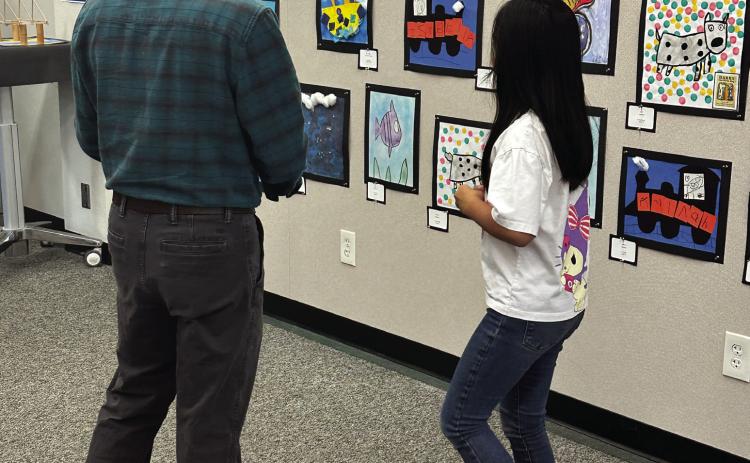 Families admire artwork created by TK 8th grade students from OVSD. PHOTOS BY JULIE SST. CRY / PUBLIC INFORMATION OFFICER, OVSD